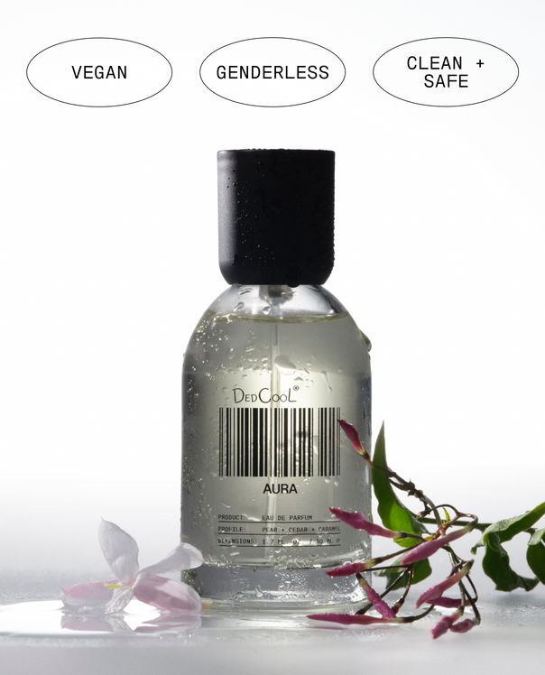 Bottle of DedCool Aura perfume with 'Vegan', 'Genderless', and 'Clean + Safe' labels on a white background.