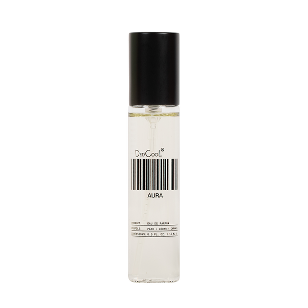 A clear cylindrical perfume bottle with a black cap, containing a very pale liquid. The bottle has a white label with a barcode and the text 'DedCoolt' and 'AURA'.
