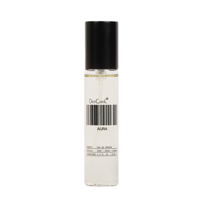 A clear cylindrical perfume bottle with a black cap, containing a very pale liquid. The bottle has a white label with a barcode and the text 'DedCoolt' and 'AURA'.